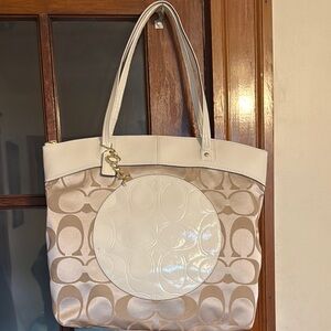 Coach “Laura” khaki and white tote bag.